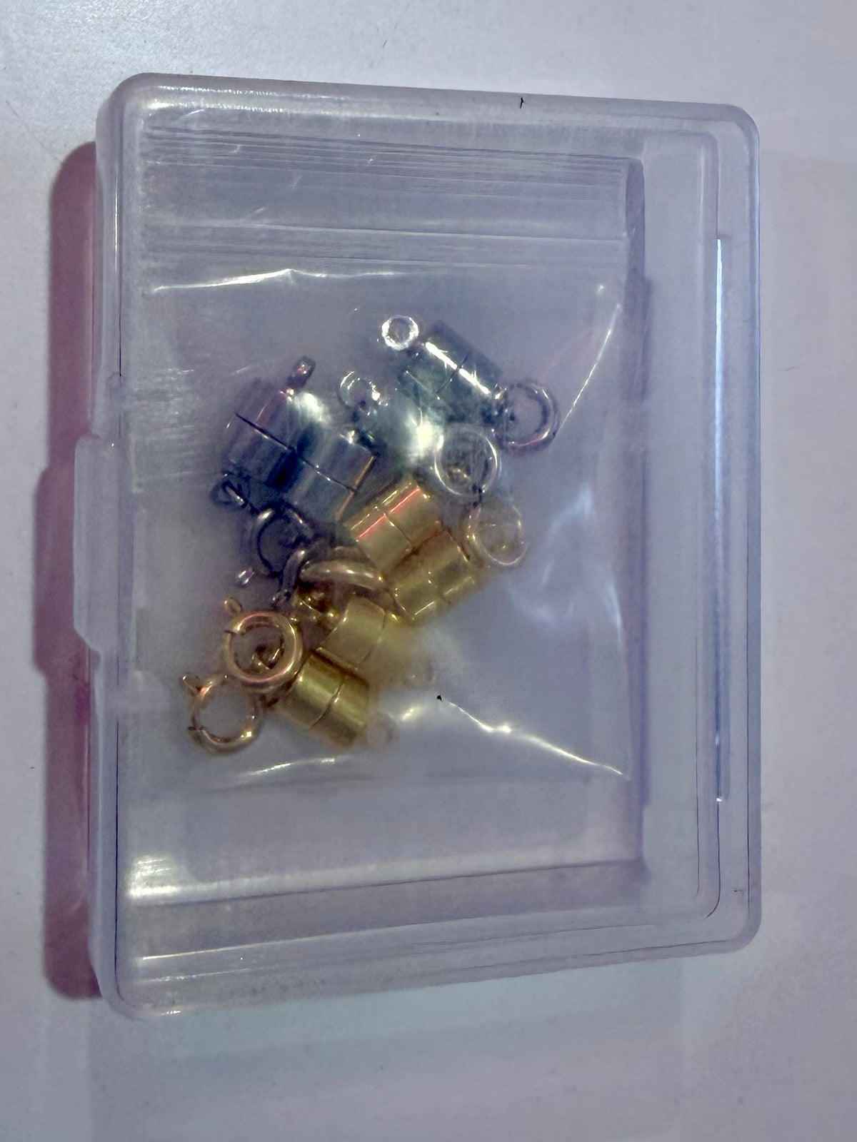 Pack of gold and silver magnetic necklace clasps with spring ring clasps in a storage case
