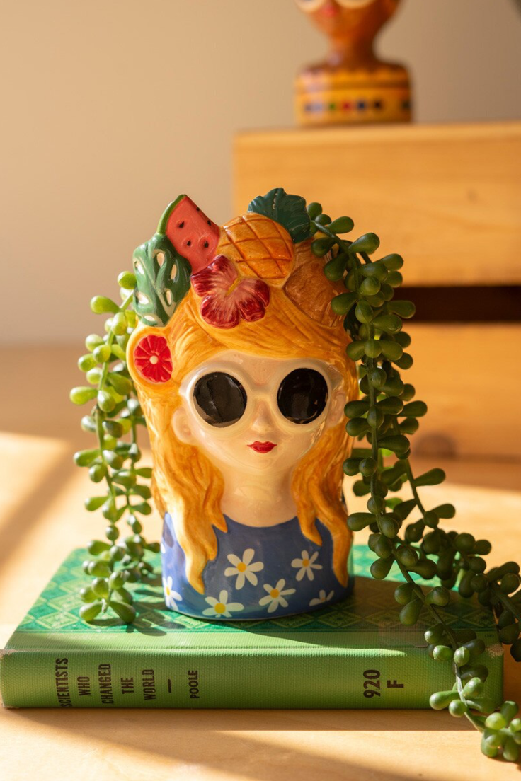 Set of three fruit crown lady planters displayed on wooden crates
