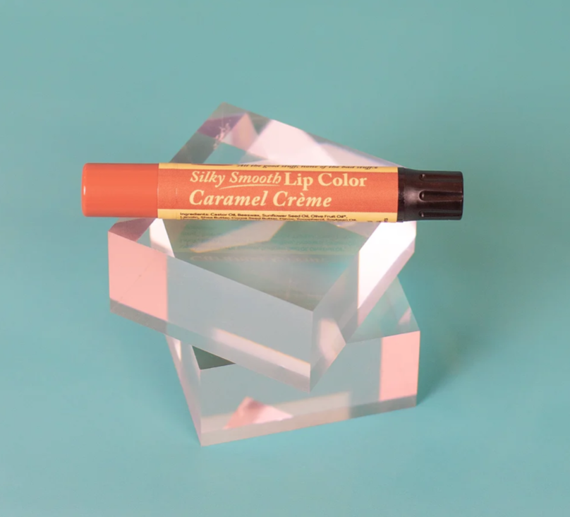 The Naked Bee Caramel Crème Silky Smooth Lip Color tube on white background