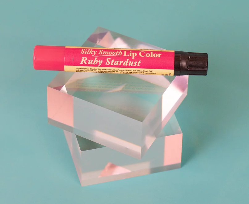 The Naked Bee Ruby Stardust Silky Smooth Lip Color tube on white background