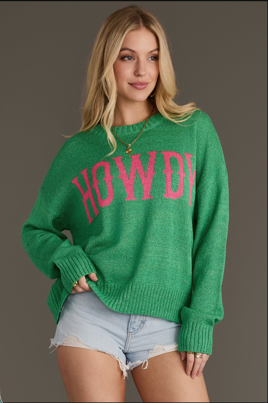 Model wearing a green Howdy lightweight sweater, angled front view