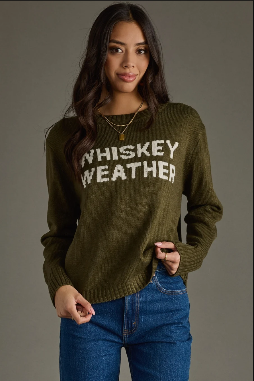 Model wearing an olive Whiskey Weather knit sweater, angled front view