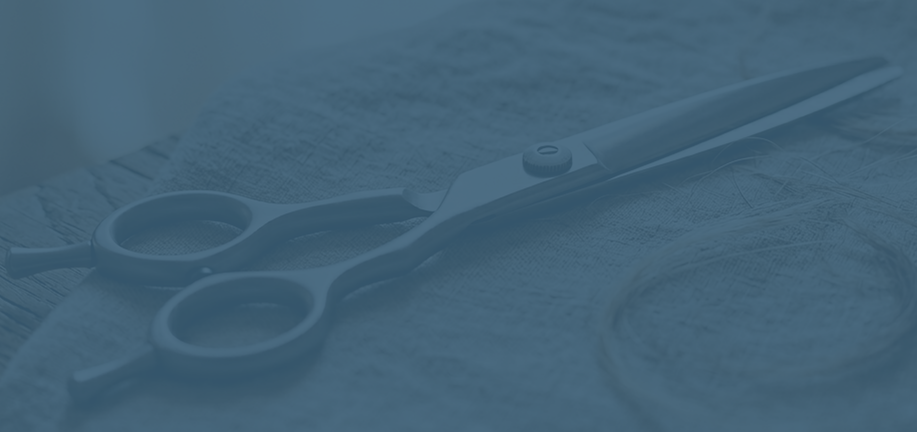 Pair of scissors on a textured surface with a blue overlay